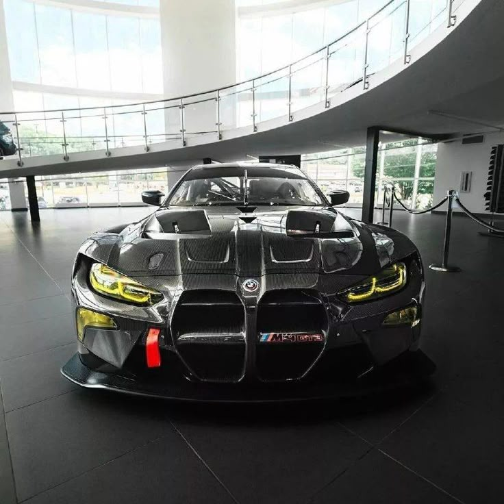 a black sports car parked in a large building