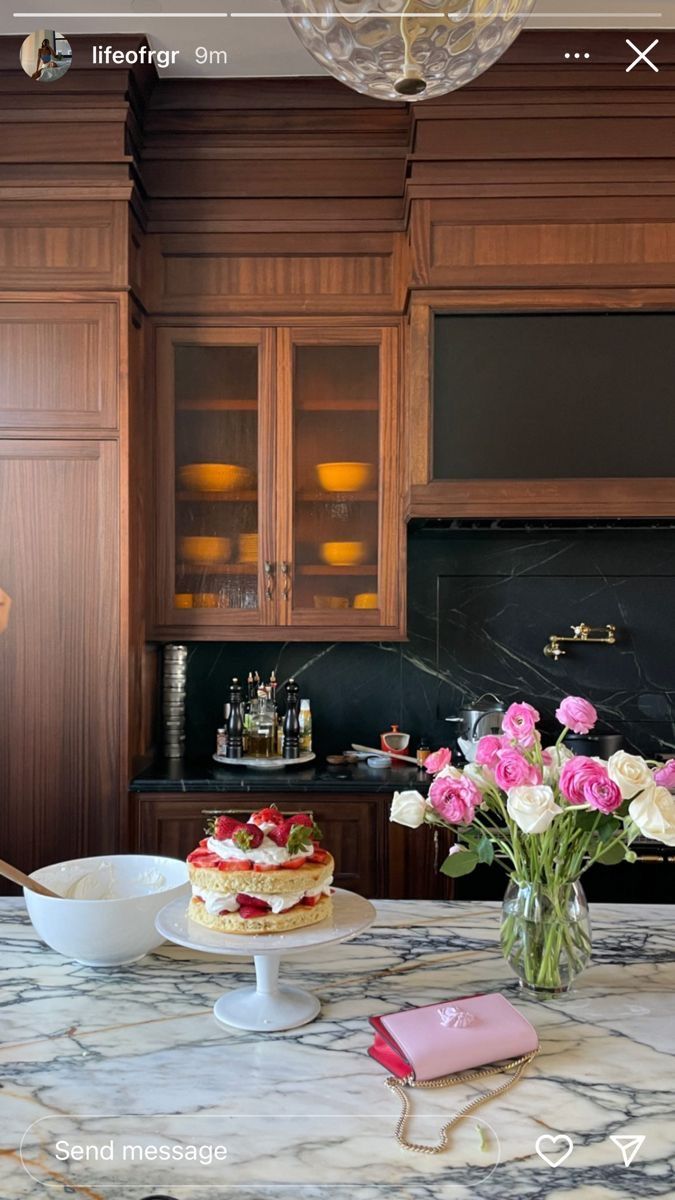 two cakes on a marble table in a kitchen