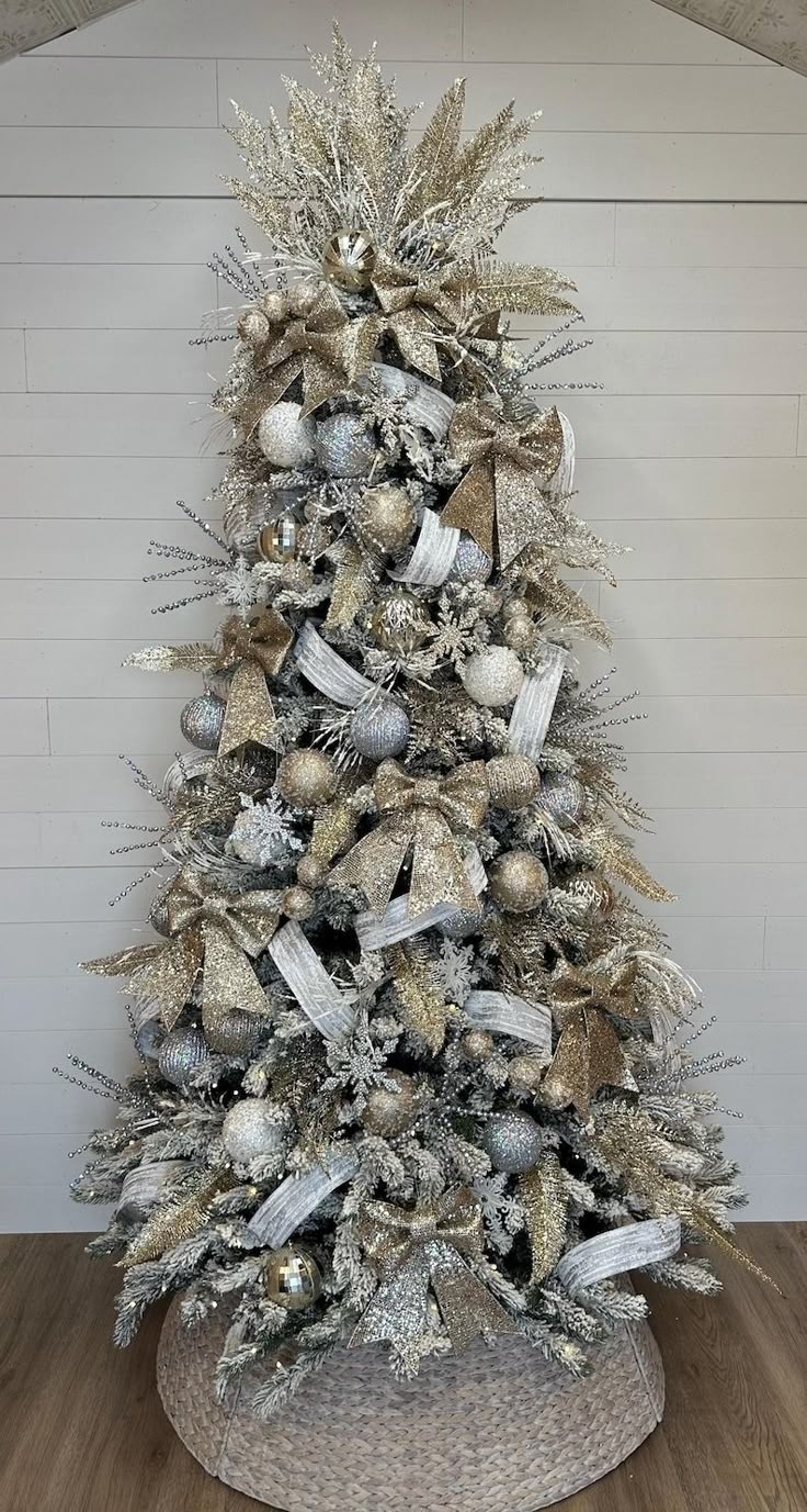 a christmas tree with silver and gold decorations