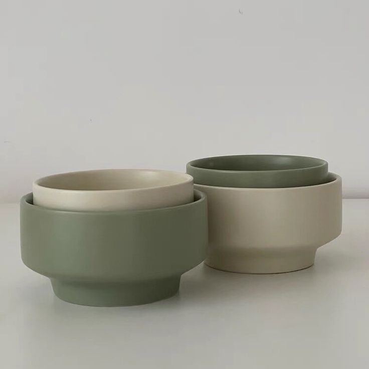 three bowls sitting next to each other on a table