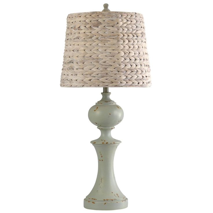 a white table lamp with a beige shade on the base and a light blue drum