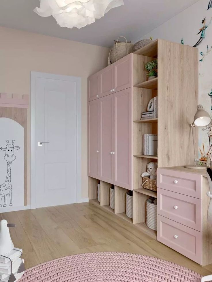 a room with pink furniture and wooden flooring, including a baby's crib