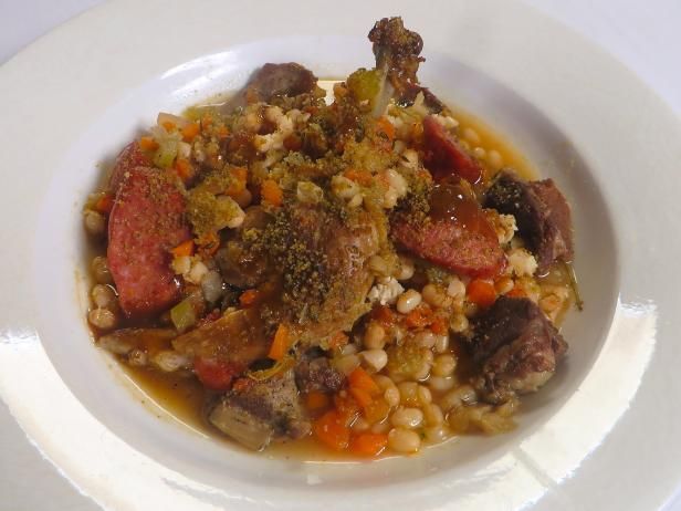 a white bowl filled with food on top of a table