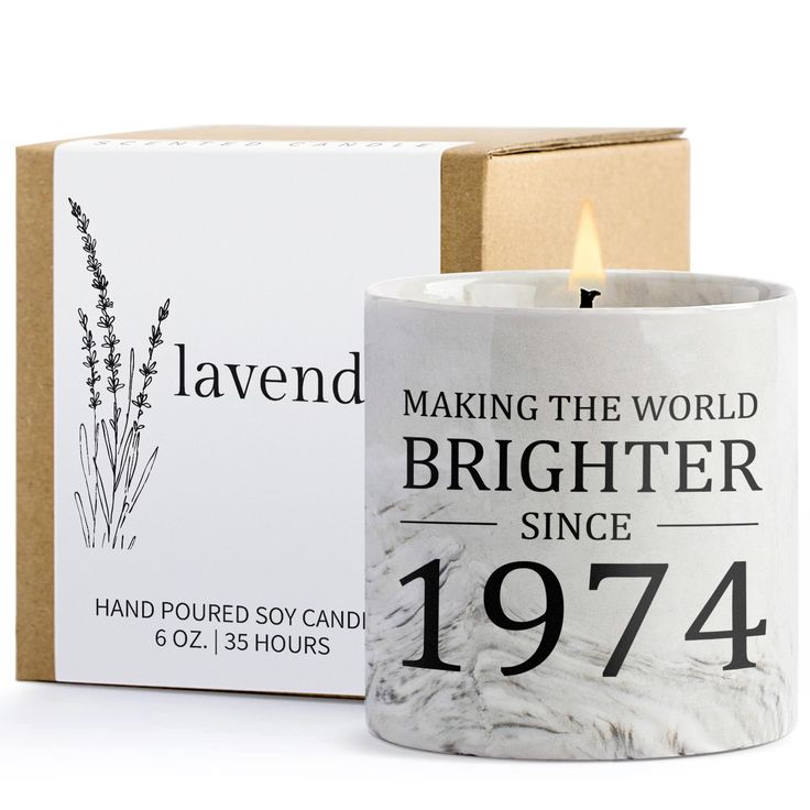 a candle that is sitting in front of a box with the words, making the world brighter since 1974