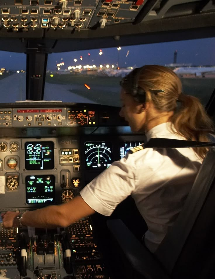 two pilots in the cockpit of an airplane at night