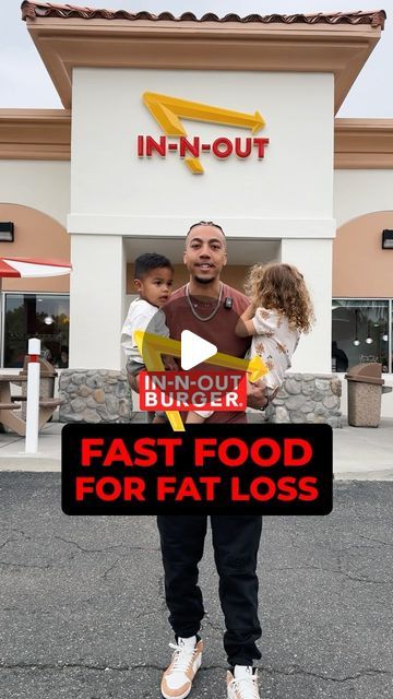 a man standing in front of a fast food store