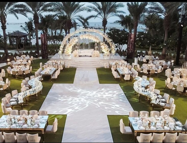 an outdoor wedding setup with tables and chairs