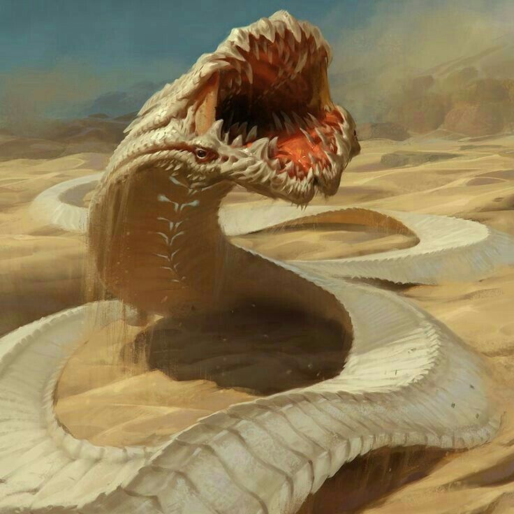 a snake with its mouth open in the desert