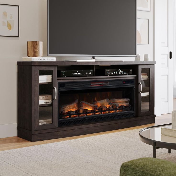 a flat screen tv mounted on top of a wooden entertainment center next to a fire place