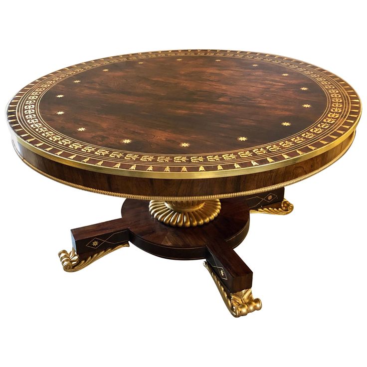 an ornately decorated wooden table with gold trimmings on the top and bottom