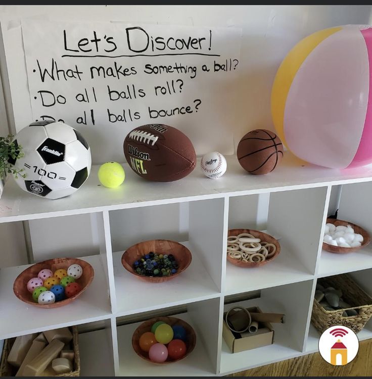 a shelf with sports balls and other items on it that says let's discovery what makes something a bill? do all balls roll?