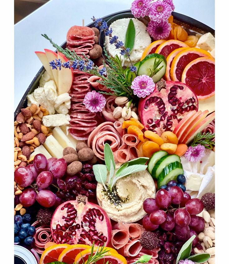 a platter filled with lots of different types of fruit and vegtables