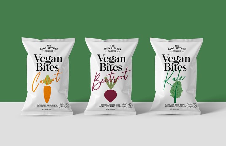 three bags of vegan bites are lined up against a green background and the bag has carrots on it