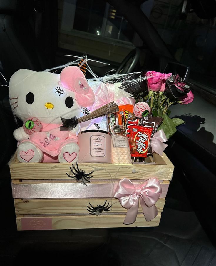 a hello kitty gift box filled with candy and flowers