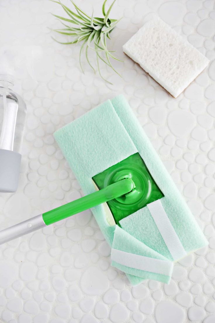 a green toothbrush sitting on top of a towel