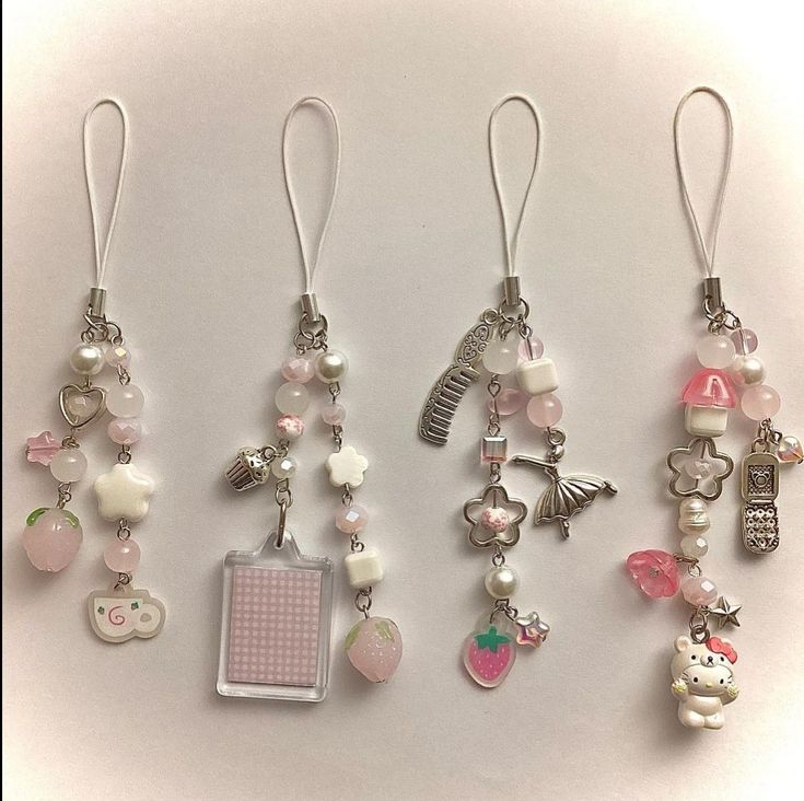 several charms are displayed on a white surface