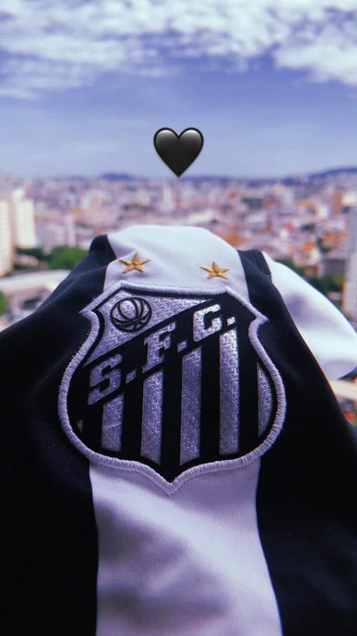 a black and white soccer jersey with a heart in the center, on top of a building