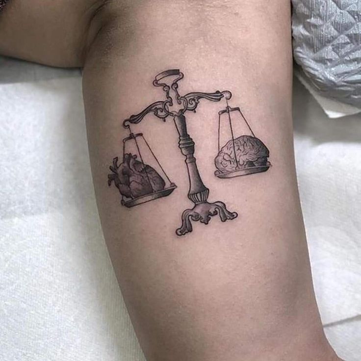 a lady justice tattoo on the leg