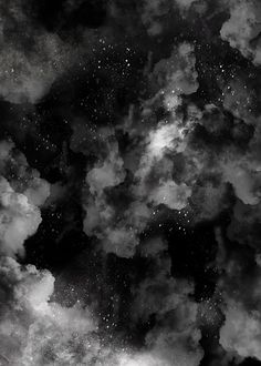 black and white photograph of clouds in the night sky with stars above it, as if from outer space