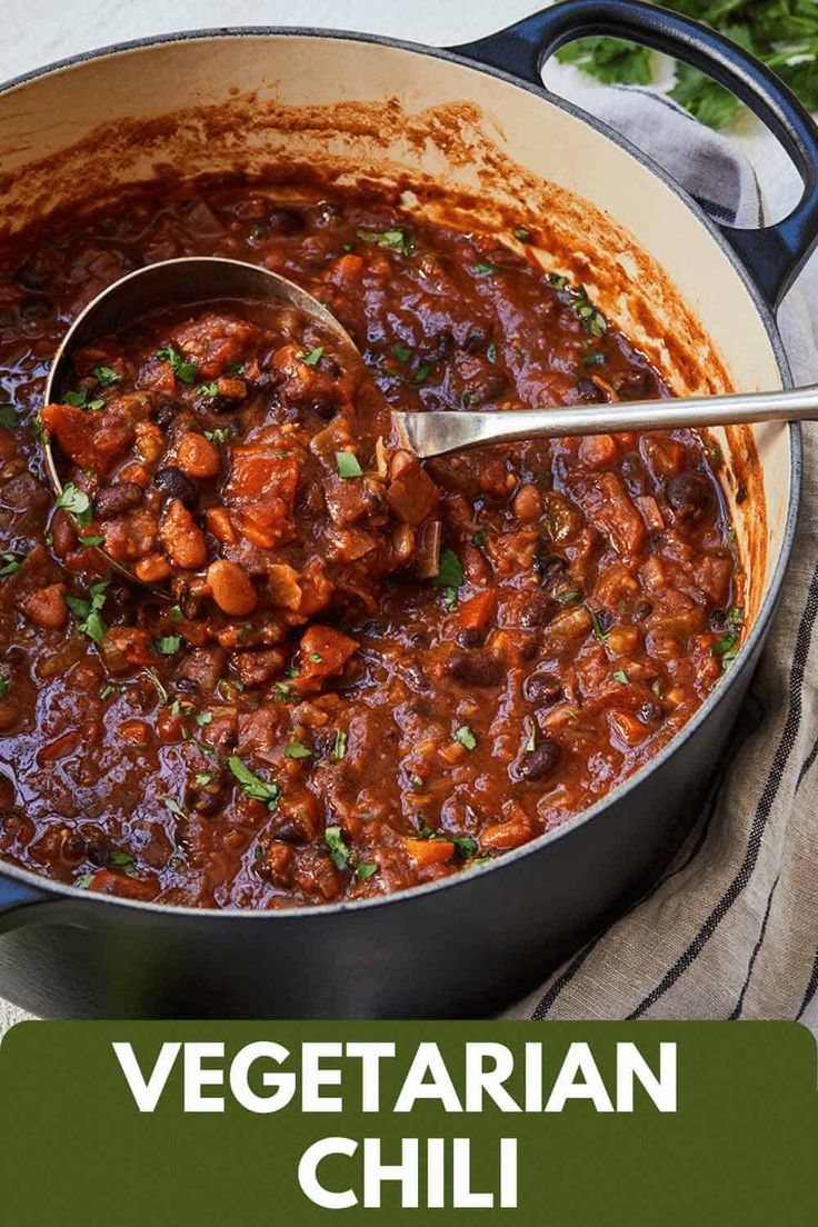 a pot full of vegetarian chili with a spoon in it and the title overlay reads, vegatarian chili