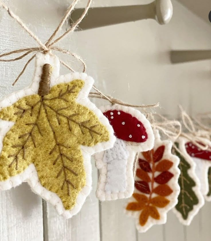 an assortment of leaf ornaments hanging from a hook