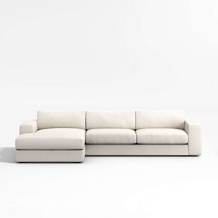 a white couch sitting on top of a white floor