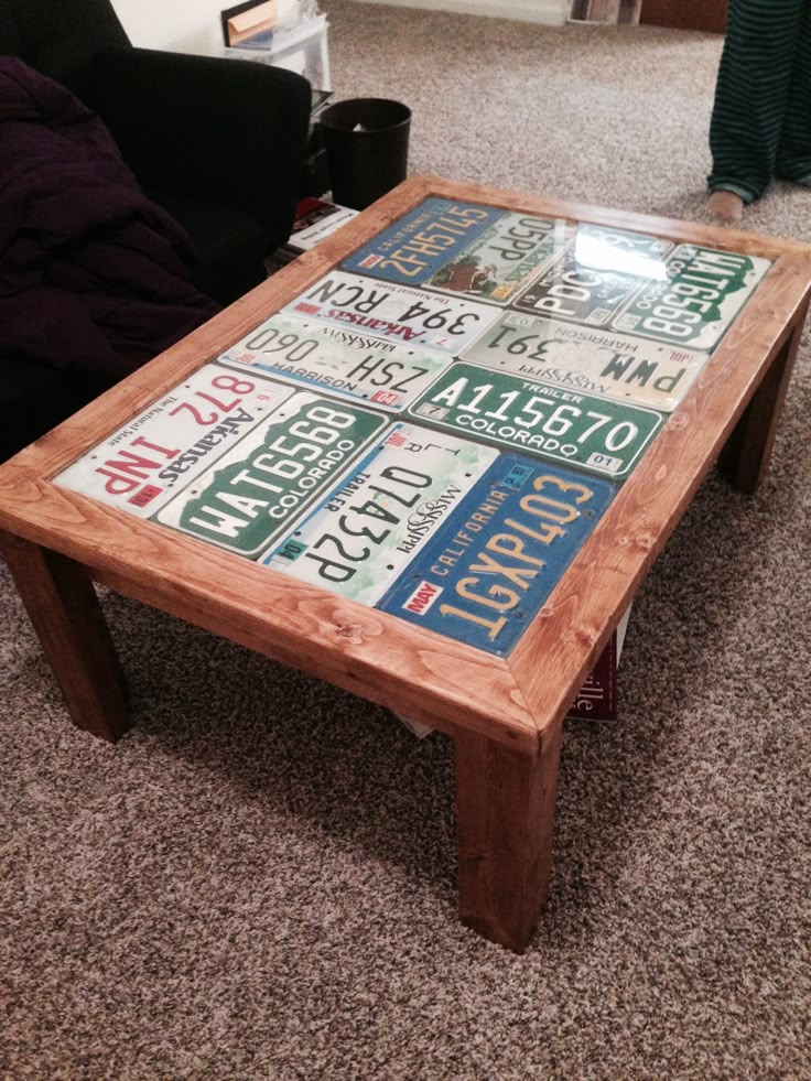 a coffee table made out of license plates on the floor in a living room area