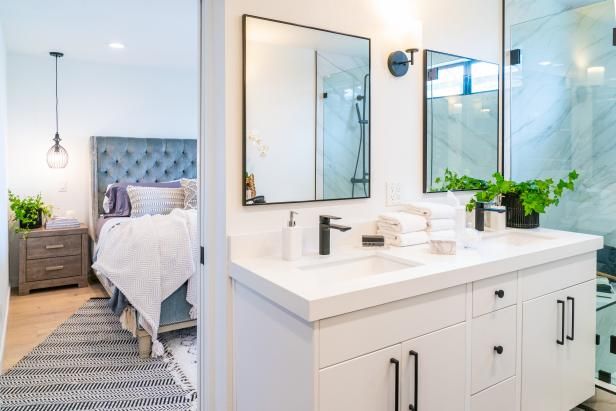 a white bathroom with two sinks and mirrors