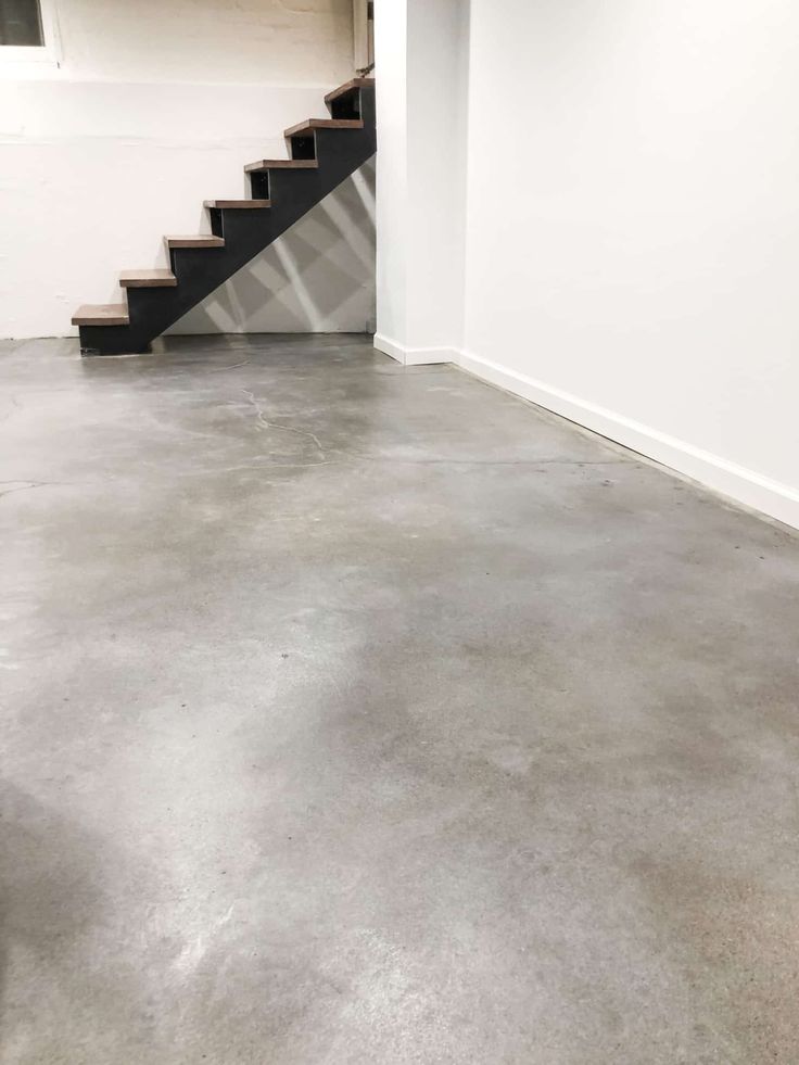 an empty room with stairs leading up to the second floor and a fire hydrant