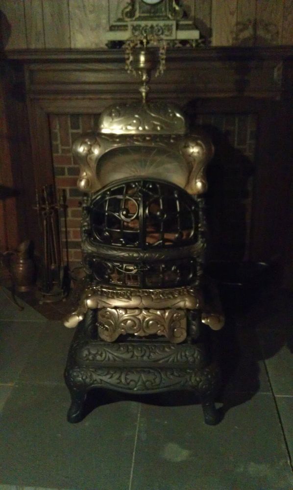 an old fashioned stove in front of a fireplace