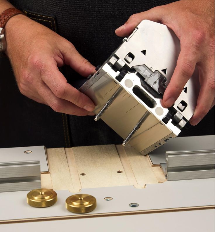 a man is working on some type of device with metal parts attached to the machine