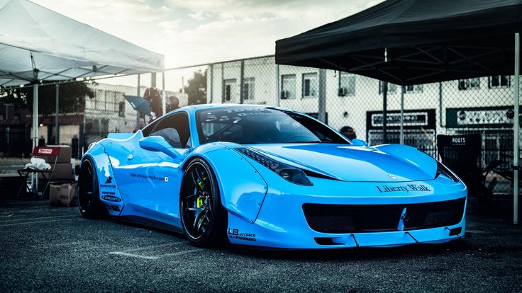 a blue sports car parked in a parking lot