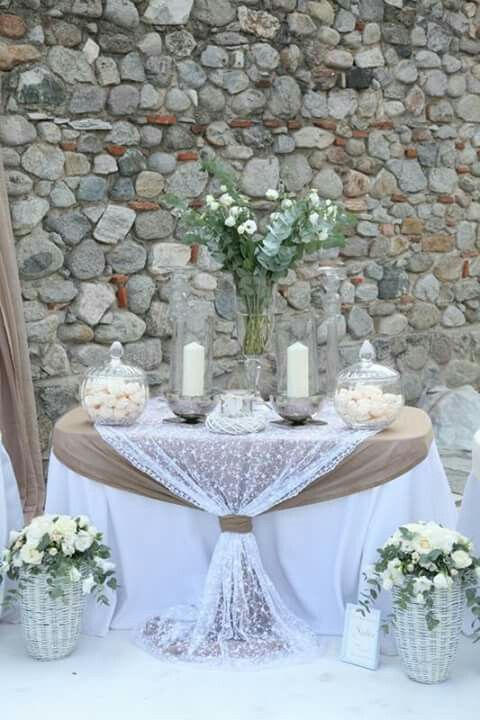 the table is set with white flowers and candles