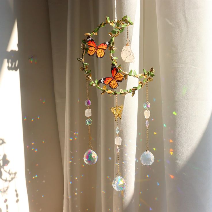 a wind chime hanging from a curtain with butterflies on it