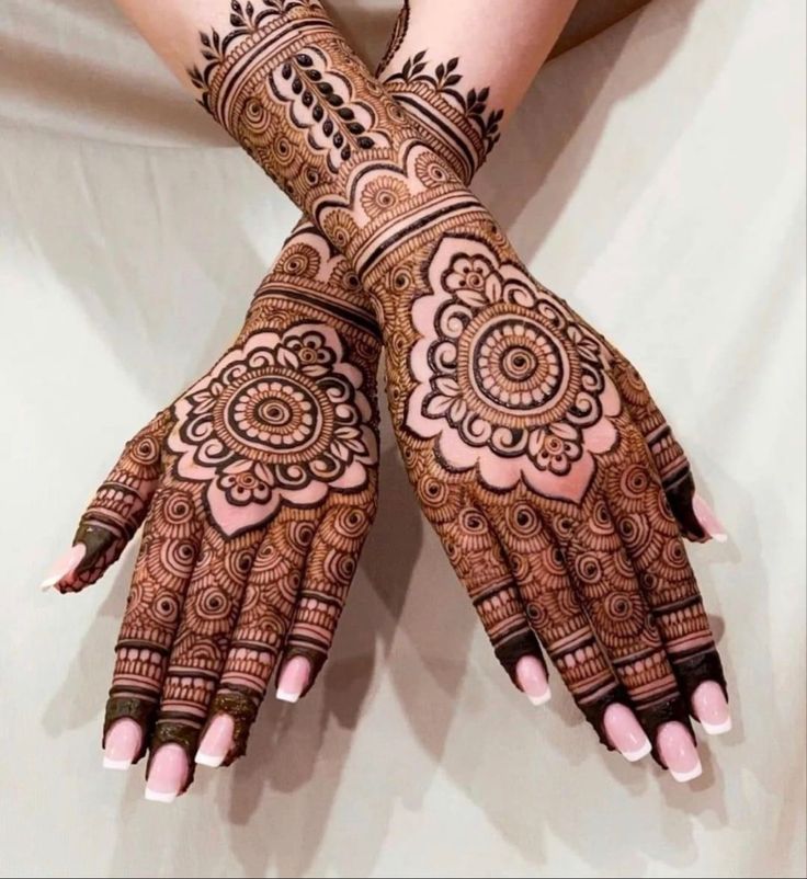 two hands with henna designs on them