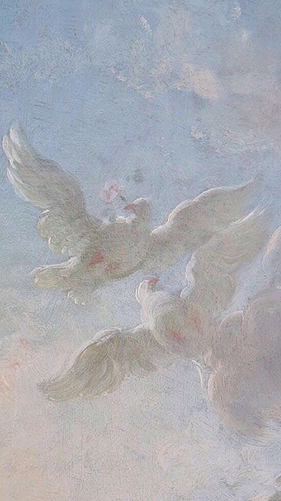 two white birds flying in the sky with clouds