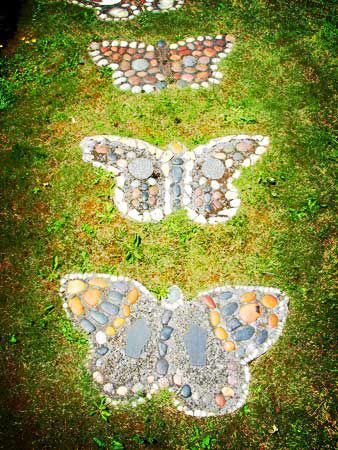 two butterfly shaped stepping stones in the grass