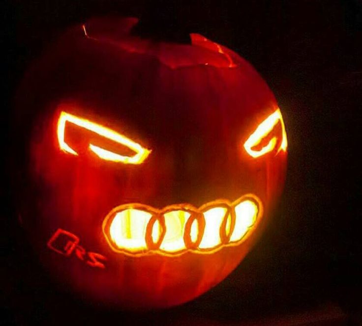 a carved pumpkin with glowing eyes and teeth