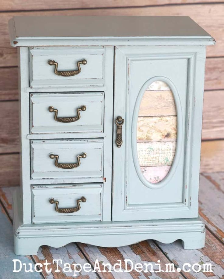 an old dresser is painted blue and has gold hardware on the doors, drawers, and handles