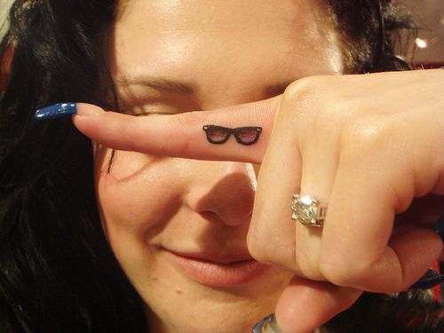 a close up of a person with a ring on their finger pointing at the camera