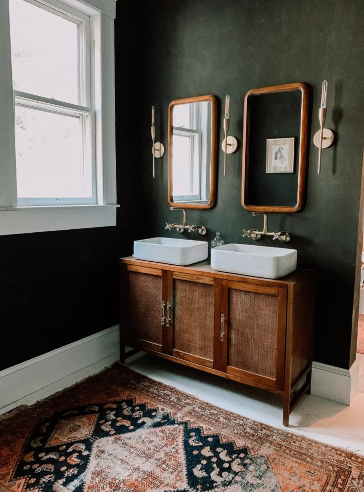 two bathroom sinks sitting next to each other on top of a rug