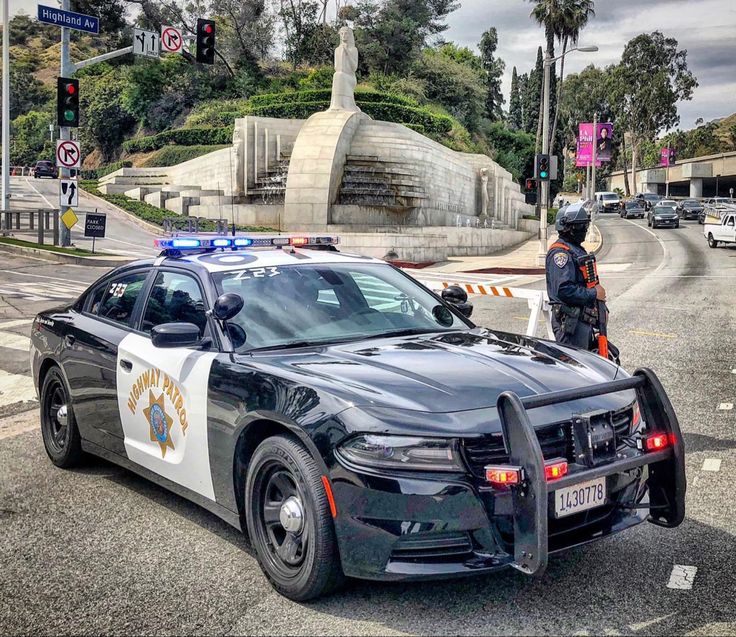 a police car is parked in front of a monument