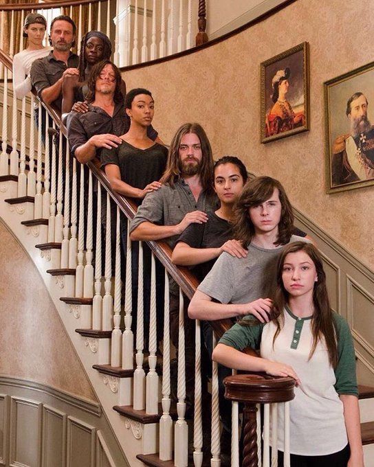 a group of people are standing on the stairs