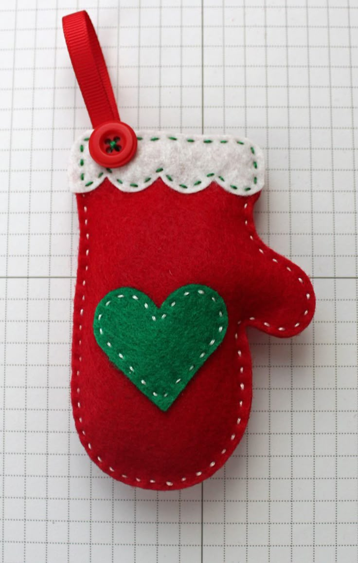 a red case with a green heart hanging from it's side on a piece of paper