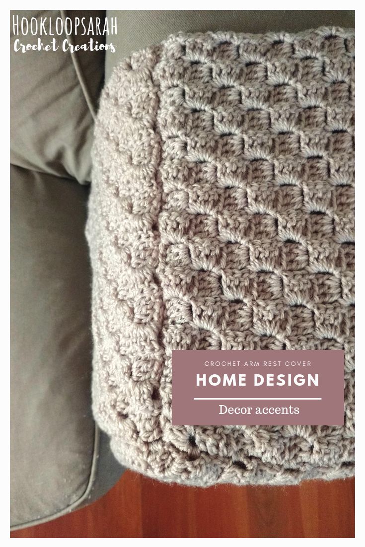 a crocheted blanket sitting on top of a couch with the words home design above it