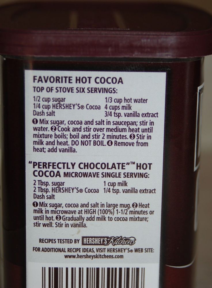 a close up of a jar of hot cocoa on a table with a price label