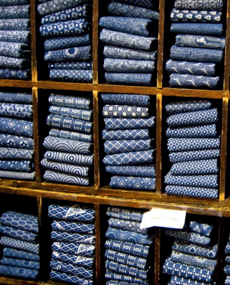 stacks of folded blue and white cloths on display