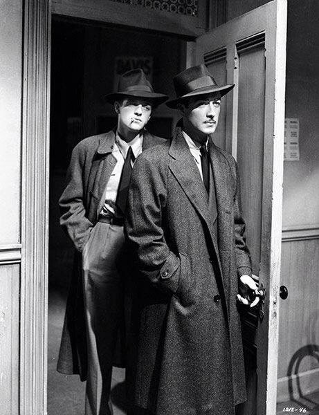 two men in suits and hats standing next to each other, both wearing coats and ties