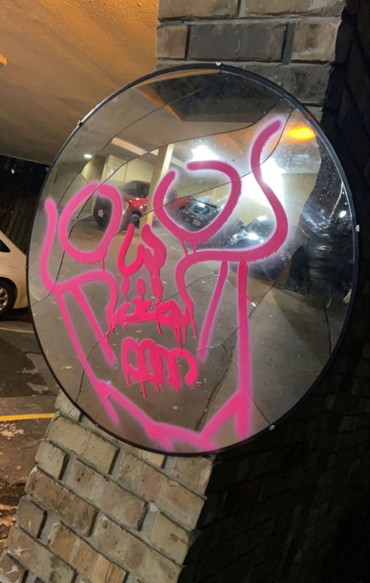 a mirror that has some graffiti on it