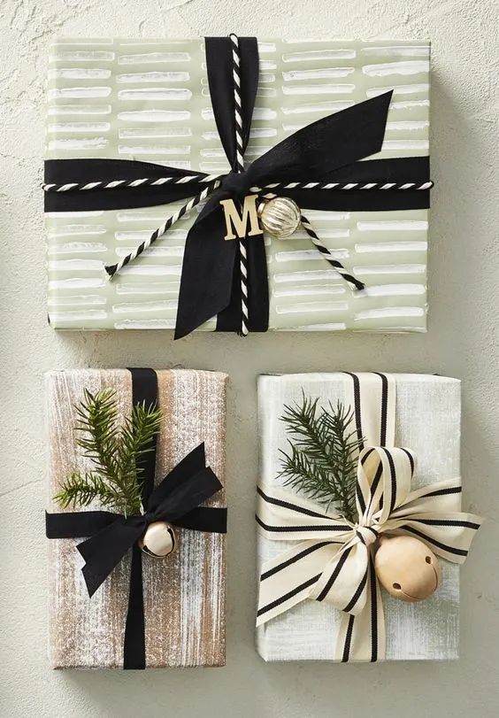 two wrapped presents with black and white ribbons